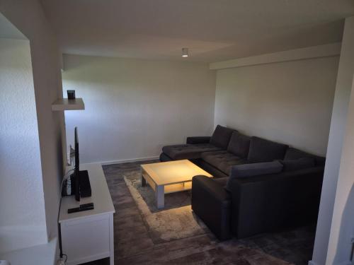 a living room with a couch and a coffee table at Sonnenterrasse in Hörup