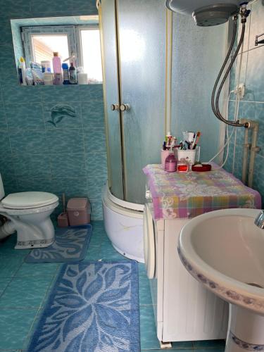 a bathroom with a sink and a toilet at Sunrise Panorama in Bokonbayevo
