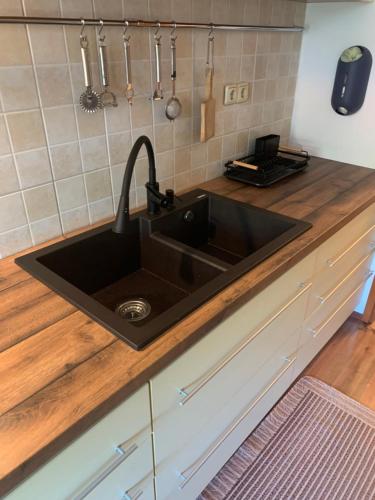 a kitchen with a black sink in a counter at Holiday Home Mirjana in Rab