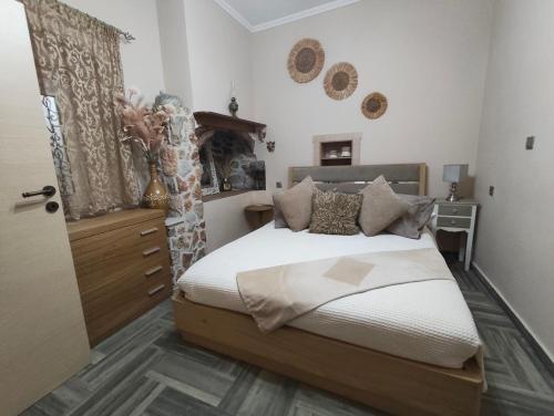a bedroom with a bed with white sheets and pillows at Vicky's House in Kos