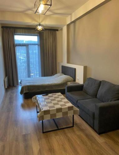 a living room with a couch and a bed at Kechi Dom 6 in Tsaghkadzor