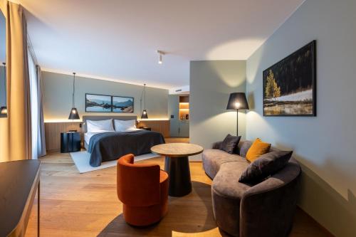 a hotel room with a bed and a couch at Hotel Rosatsch Residence in Pontresina