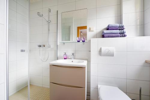 a white bathroom with a sink and a shower at Landpension Risch in Ilmenau