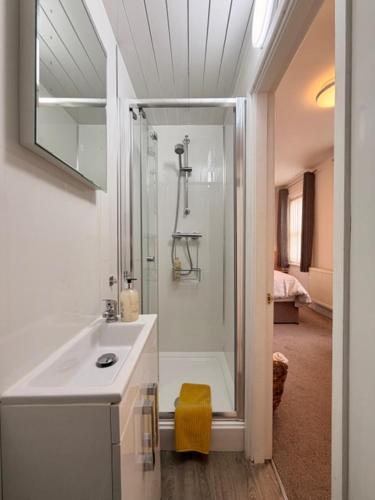 a bathroom with a shower and a sink at Avenue Guest House in Blackpool