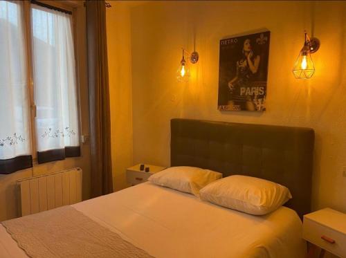a bedroom with a bed and a poster on the wall at Villa Antibes Chez Celine in Étaples