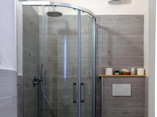 a shower with a glass door in a bathroom at Hotel Da Giovanna in Chiusi della Verna