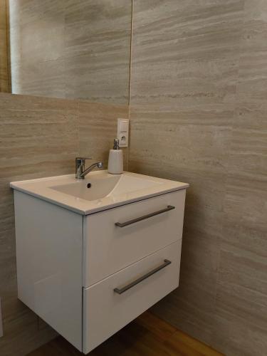 a bathroom with a white sink and a mirror at Piękny zielony zakątek na Kaszubach - agroturystyka z jacuzzi in Strzepcz