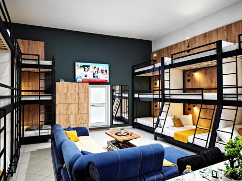 a living room with bunk beds and a couch at City Center Hostel Durres in Durrës