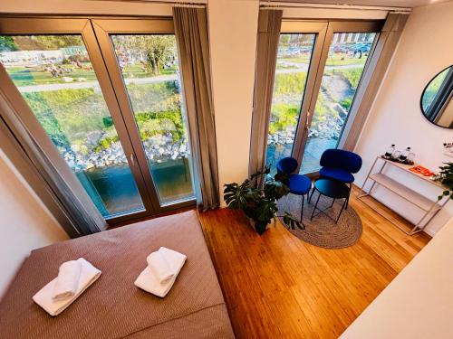 a living room with two large windows and a couch at Sundeck botel - party boat in Bratislava