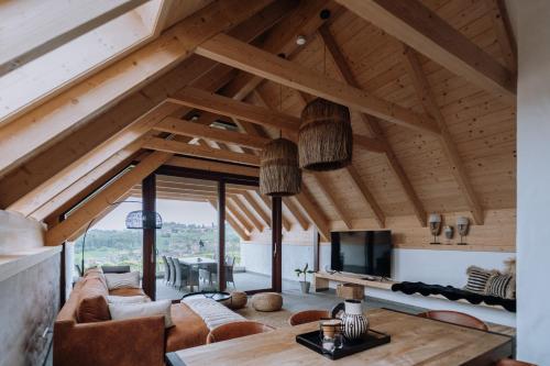 a living room with a couch and a tv at Winzerhof - Deutsch Haseldorf in Deutsch Haseldorf