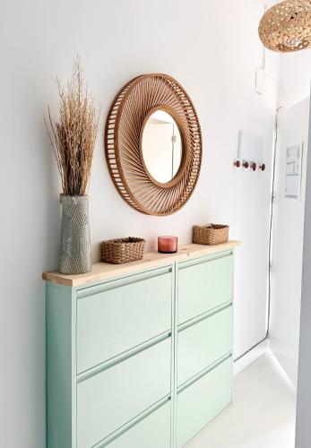 a mirror on top of a dresser in a room at Precioso bungalow con piscina en 1a Linea Playa in Denia