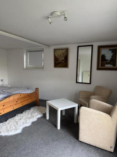 a bedroom with a bed and a couch and a table at Haus Hubertus in Willingen