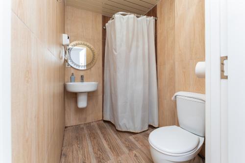 a bathroom with a toilet and a sink at Alex Hotel in Yerevan