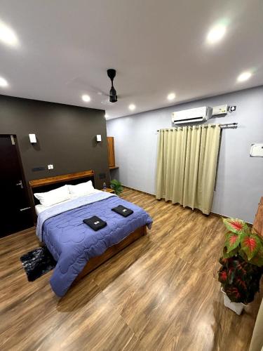a bedroom with a large bed in a room at Creek Cottage in Kollam