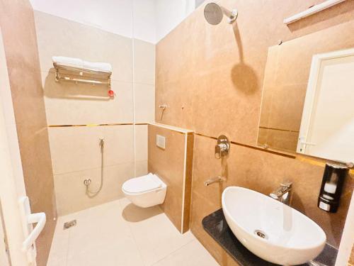 a bathroom with a sink and a toilet and a shower at The RK Resort in Siwān