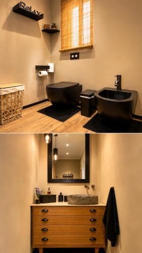 a bathroom with a black sink and a mirror at D'Arte Suite in Tal-Liedna