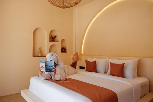 two stuffed animals sitting on a bed in a room at Miliyana Boutique Hotel - Adults Only in Kuta Lombok