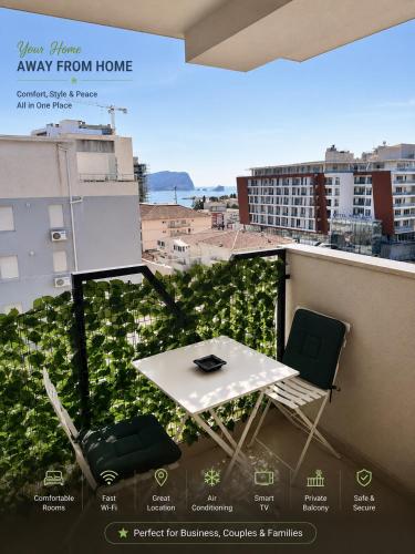 a balcony with a table and chairs on a roof at Luxury Budva Apartment in Budva