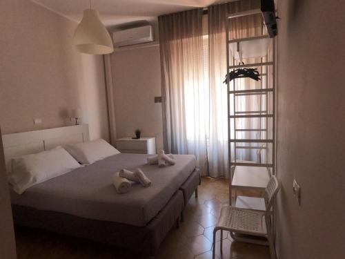 a bedroom with a bed with two towels on it at T Hotel- Adults Only, Pet Free Hotel in Rimini