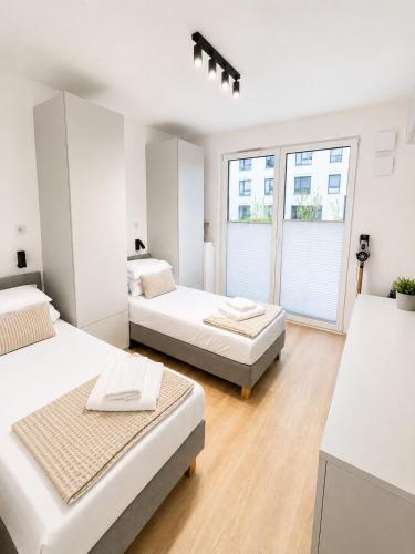 a bedroom with two beds and a window at APARTAMENT 4 bed 2 room WARSAW in Warsaw