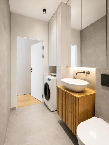 a bathroom with a sink and a washing machine at APARTAMENT 4 bed 2 room WARSAW in Warsaw