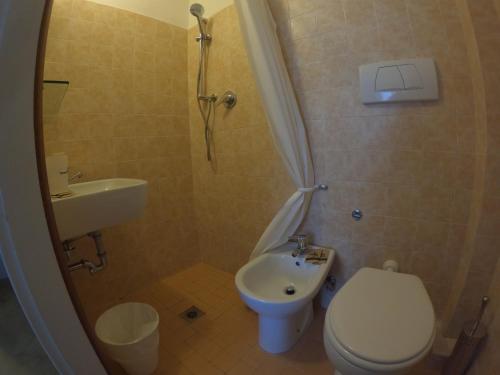 a small bathroom with a toilet and a sink at T Hotel- Adults Only, Pet Free Hotel in Rimini