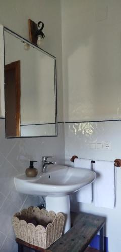 a bathroom with a white sink and a mirror at El Molino de Iramala in Reolid