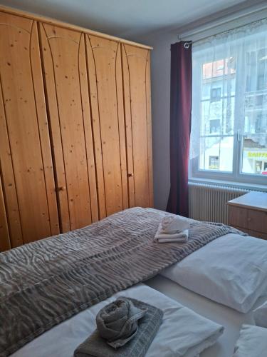 a bedroom with a bed and a large window at BlumentrittAppartment in Sankt Aegyd am Neuwalde