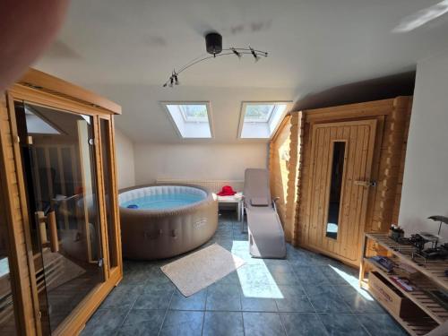 a bathroom with a large tub in the middle of a room at BlumentrittAppartment in Sankt Aegyd am Neuwalde