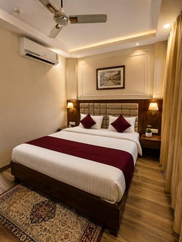 a bedroom with a large bed in a room at Hotel Lotus Palace in Lucknow
