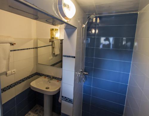 a small bathroom with a sink and a shower at Riad Dar Bab Guissa in Fès