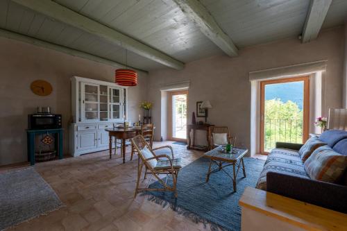 a living room with a couch and a table at La Terrazza di Rivoria - Vue magique & Terrasse in Masera