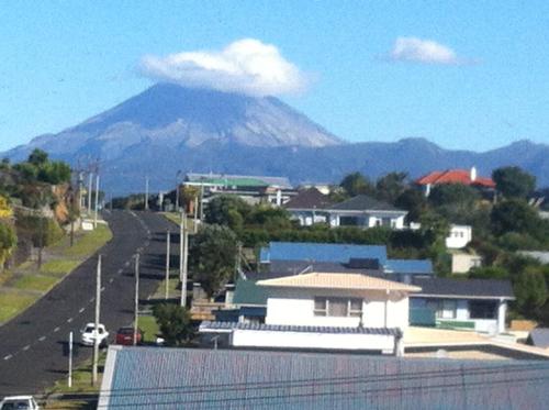 a mountain in the distance with houses and a road at 58 Pioneer - Retro Studio Unit in New Plymouth