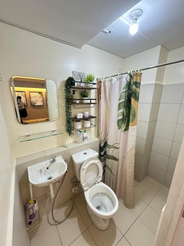 a bathroom with a toilet and a sink at SM Bicutan Staycation by Urban Suite in Manila