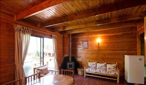 a living room with a couch and a stove at Añañucas III in Las Trancas