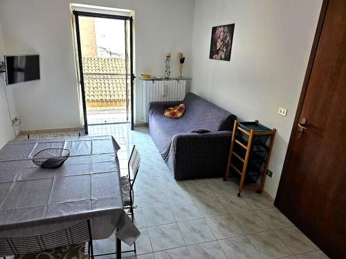 a living room with a couch and a table at Casa Cordara Apartment in Nizza Monferrato