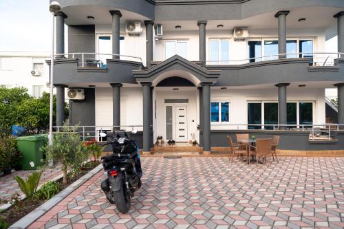a motorcycle parked in front of a house at Rexha Apartments in Ulcinj