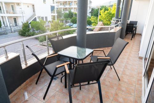 a balcony with a table and chairs on a balcony at Rexha Apartments in Ulcinj