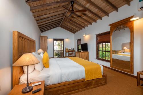a bedroom with a large bed and a television at The Colonial Escape in Galle