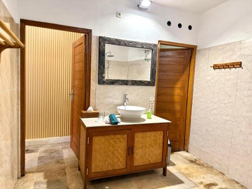 a bathroom with a sink and a mirror at Alam Mimpi Bali in Tejakula