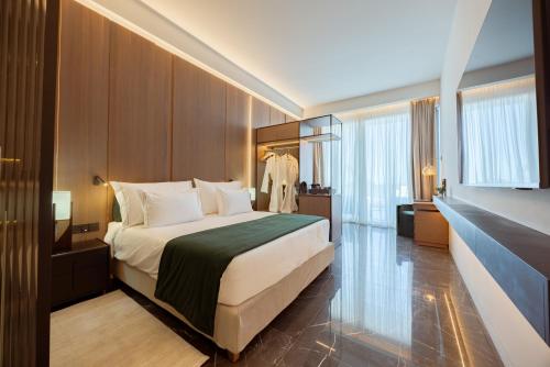 a bedroom with a large bed in a room at Serbellas Boutique Hotel in Paphos