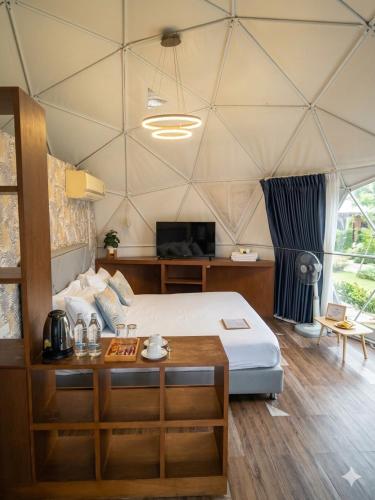 a bedroom with a bed in a tent at PaPa Q suite Resort in Roi Et