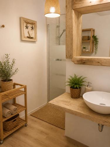 a bathroom with a sink and a shower at Apartamentos Es Cupina in La Mola