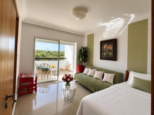 a living room with a bed and a couch at perfect 2 bedrooms 2 balconies pool and golf in Asilah