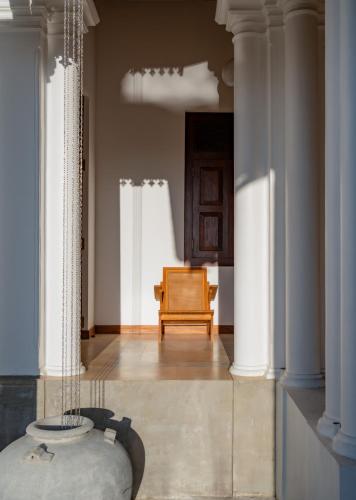 a living room with a chair and a table at The Colonial Escape in Galle