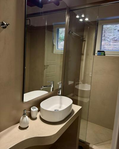 a bathroom with a sink and a shower at PANORAMIO in Batsi