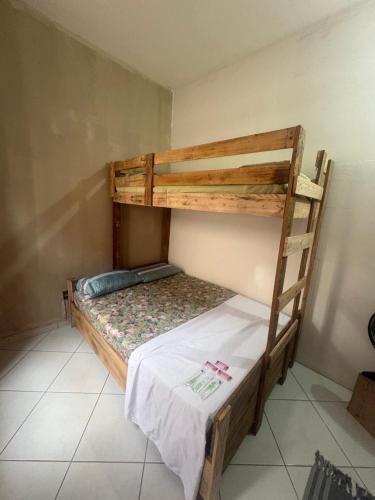 a bedroom with two bunk beds in a room at Pousada cosmo in Uberaba