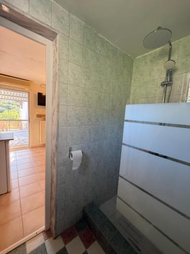 a bathroom with a roll of toilet paper on the wall at The Garden Studio AVLI Upper Vrasna in Nea Vrasna