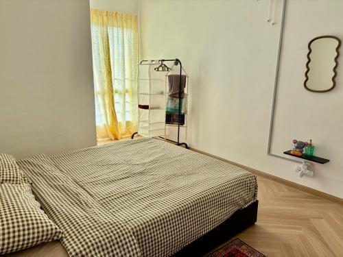a bedroom with a bed in a room with a window at Yunis Cottage Tranquil mountain views Centrum Cameron Highlands in Brinchang