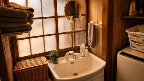 a bathroom with a sink and a mirror at ペットok 古民家ふるさと真鶴 in Manazuru